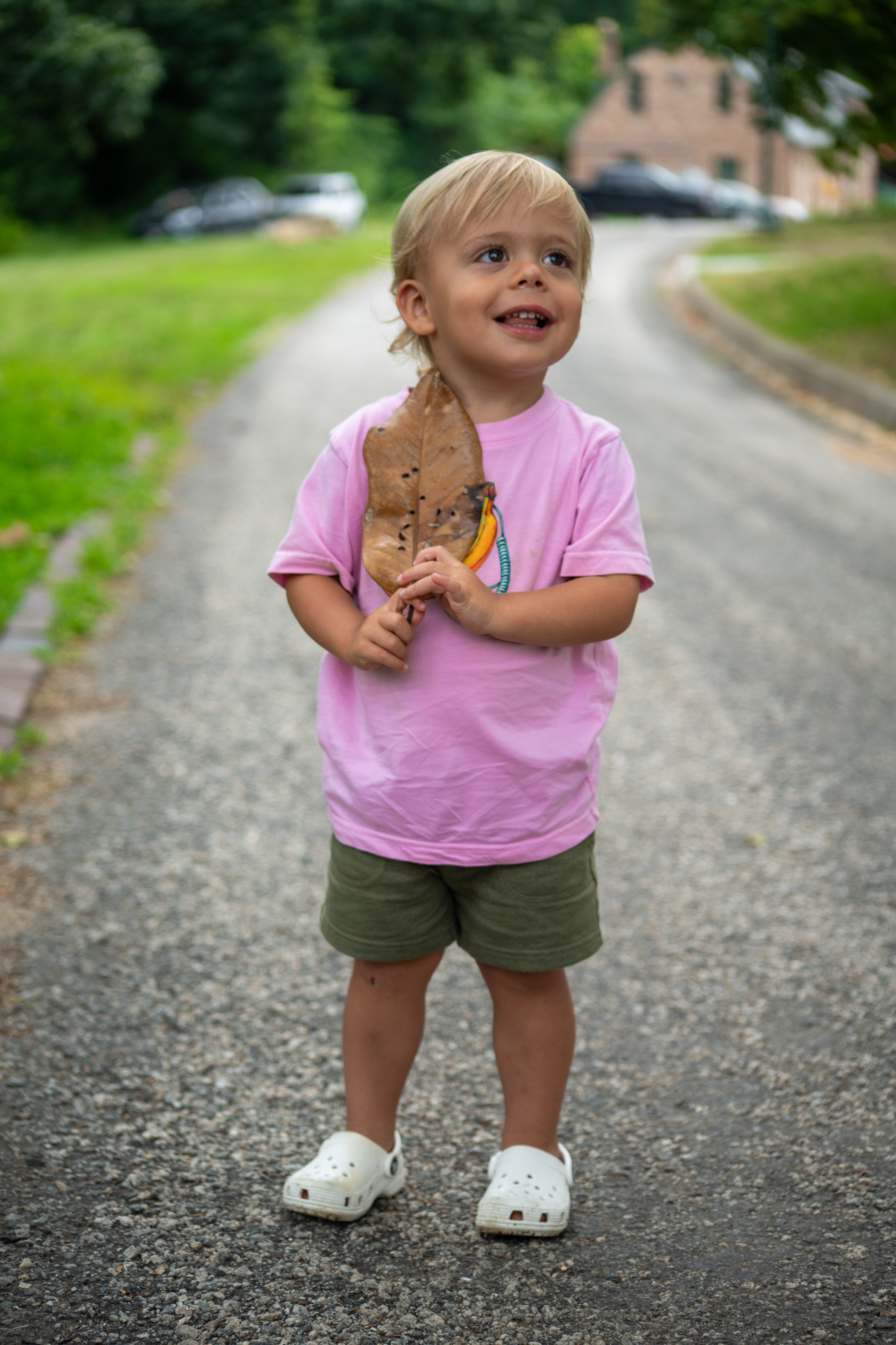 Theo Family - smiling holding large leaf